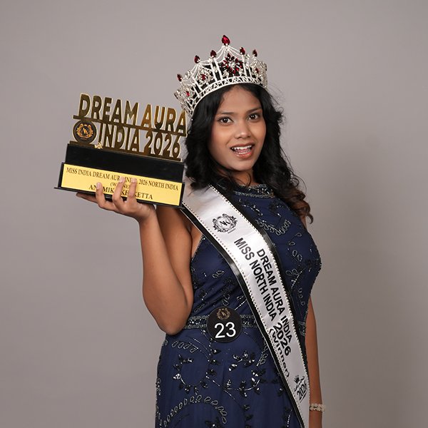 Anamika Kerketta  wearing her crown and sash while holding the Dream Aura India 2026 trophy as the North India Winner..