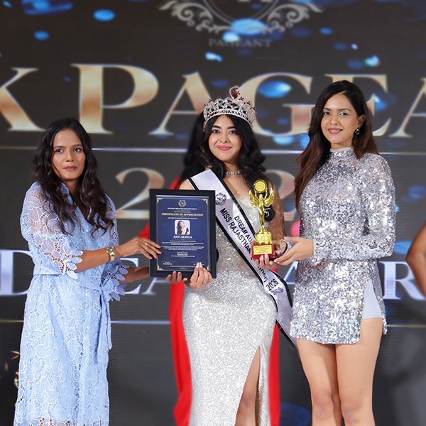 Anvi  Monga wearing her crown and sash while holding a trophy and certificate as the Rajasthan Winner at Dream Aura India 2026.