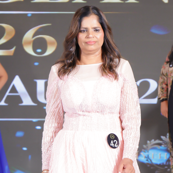 Krishna Rana walking confidently on stage in a white gown during the Dream Aura India 2026 pageant ramp walk.