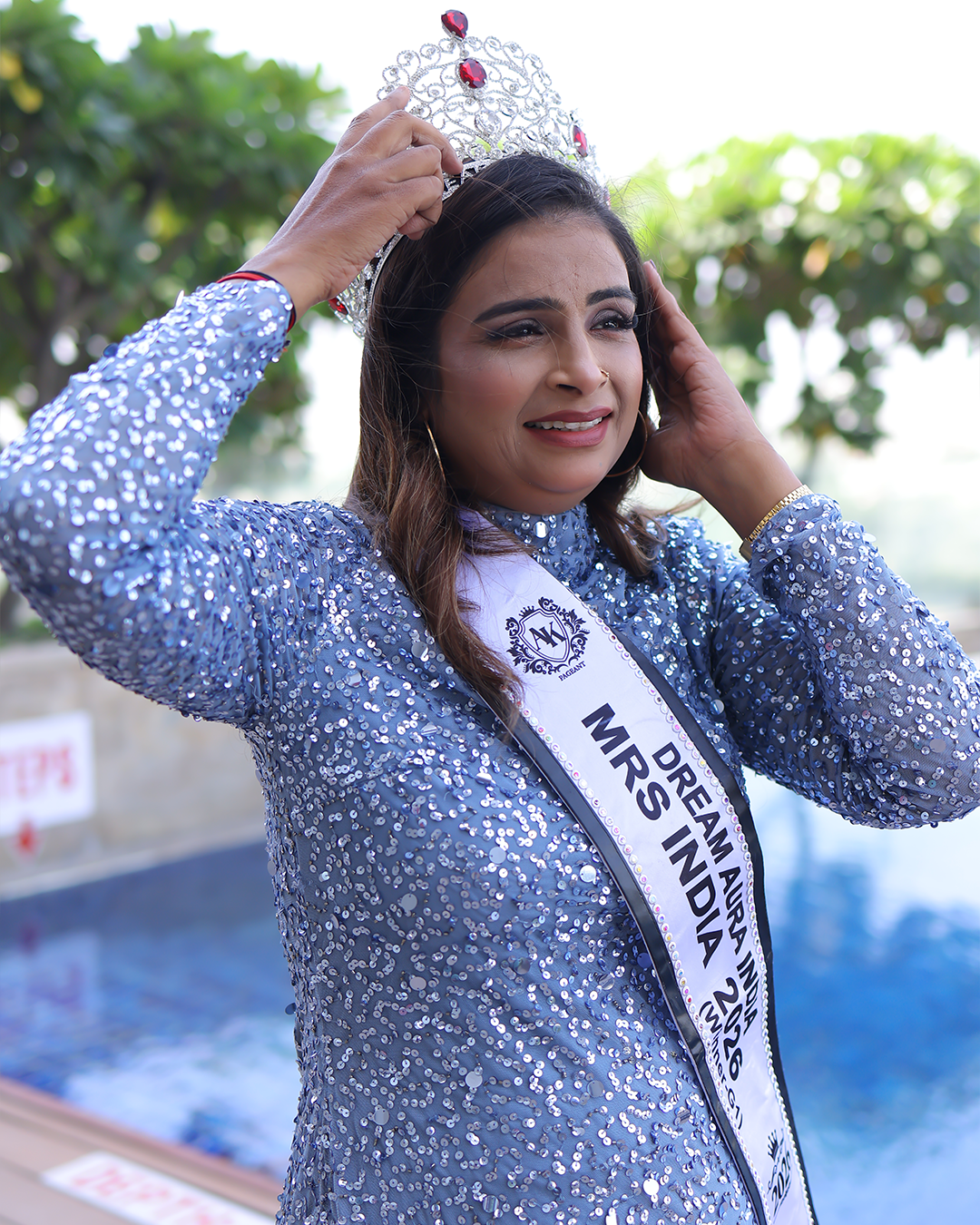 Shakila Ahmed proudly wearing the Mrs Dream Aura India 2026 crown and sash